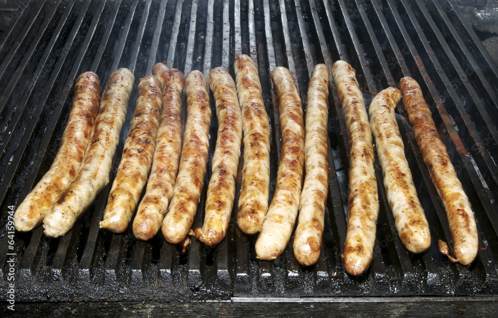 cooking sausages on the grill in the restaurant cooking sausages on the grill in the restaurant