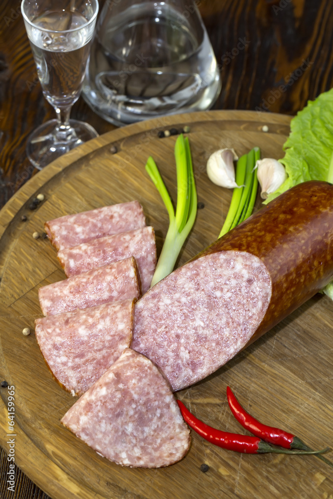 sausage on a wooden plate in a restaurant sausage on a wooden plate in a restaurant
