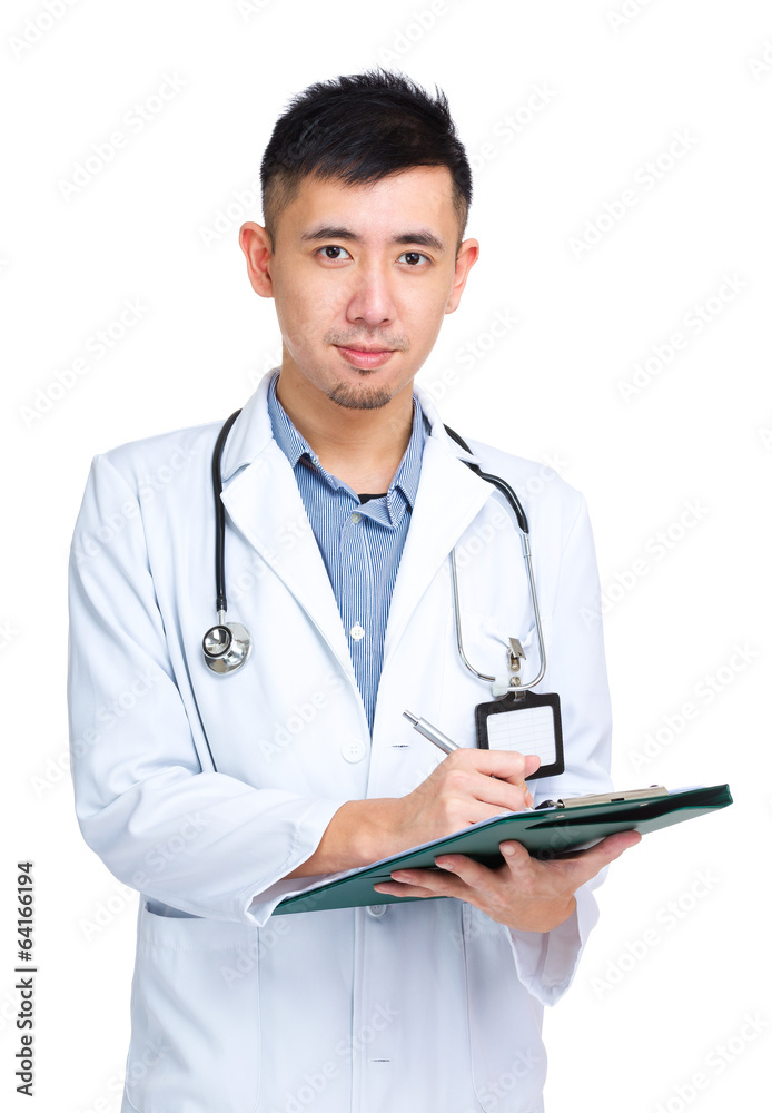 Young asian doctor writing prescription on clipboard Young asian doctor writing prescription on clipboard