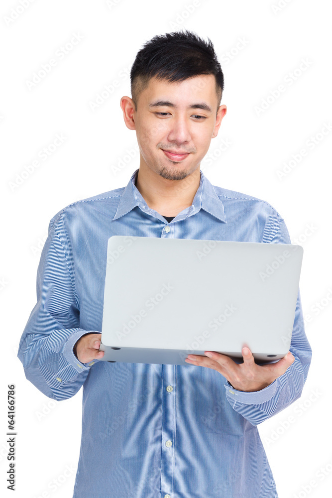 Young man reading on laptop computer Young man reading on laptop computer