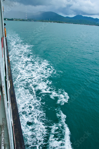 passenger ship water trail leaving form an islan
