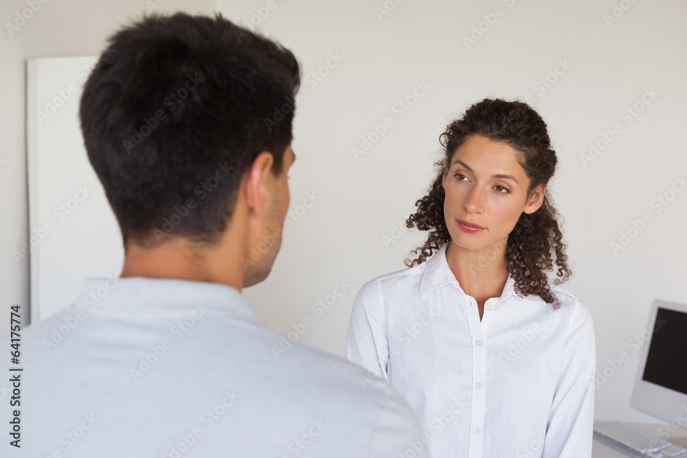 Casual business partners looking at each other Casual business partners looking at each other
