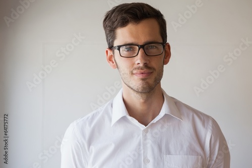 Casual businessman smiling at camera wearing glasses © WavebreakMediaMicro