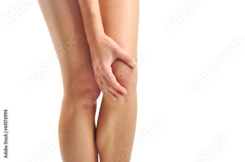 Woman touches her leg by hand  white background