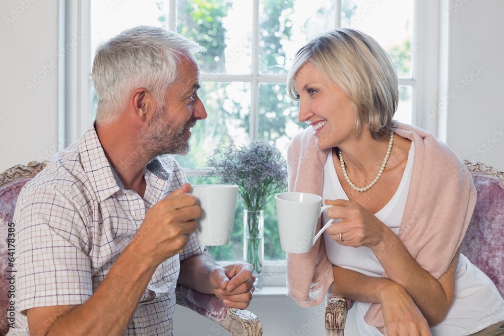 Mature couple with coffee cups at home Mature couple with coffee cups at home