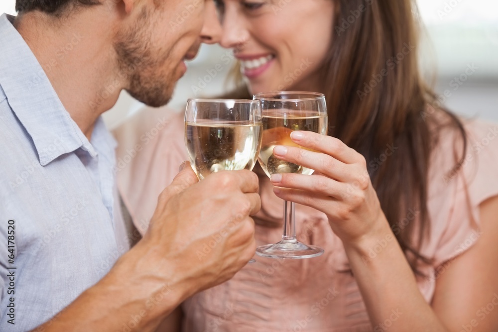 Close-up of a couple toasting wine glasses Close-up of a couple toasting wine glasses
