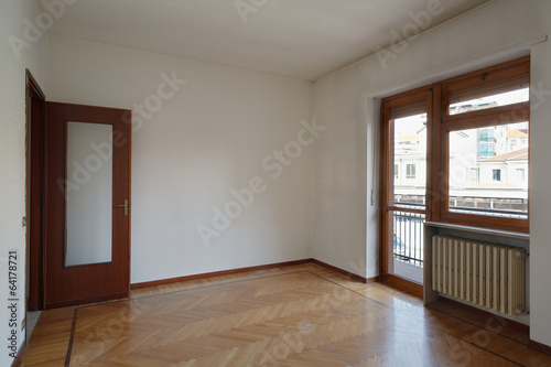 Empty room in normal apartment with wooden floor