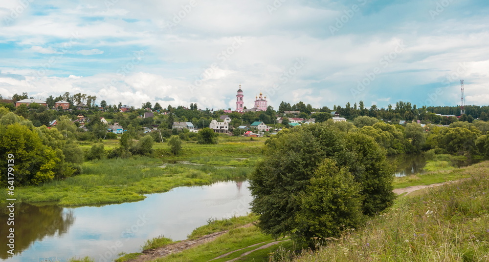 summer landscape with river, meadow, road and church