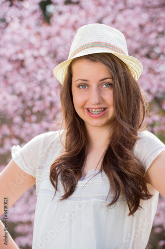 Girl with braces wearing hat spring blossom © CandyBox Images