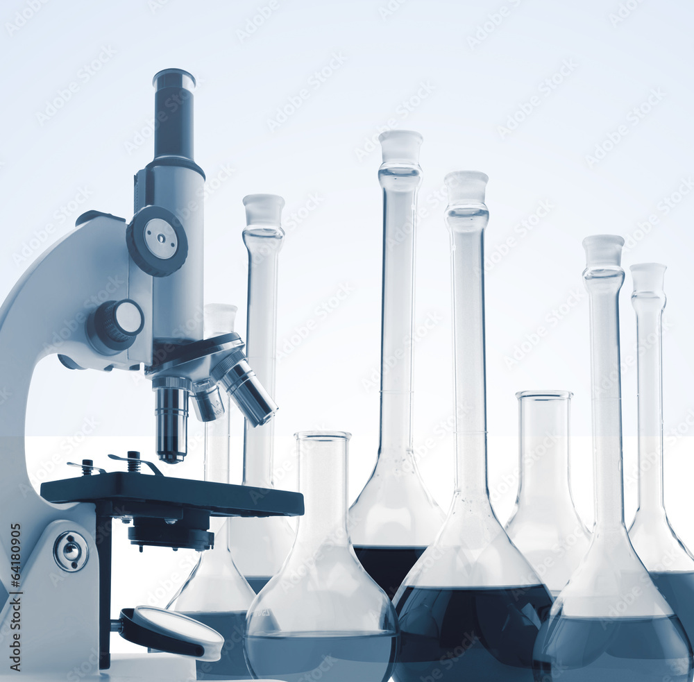 Laboratory metal microscope and test tubes with liquid toning in