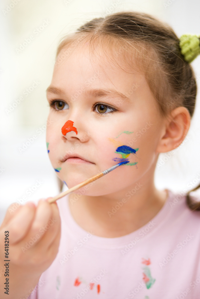 Portrait of a cute girl playing with paints Portrait of a cute girl playing with paints