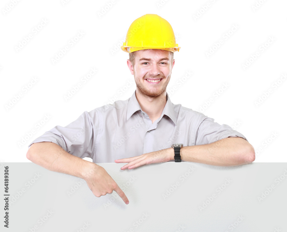 Young man holding blank billboard wearing hard hat Young man holding blank billboard wearing hard hat