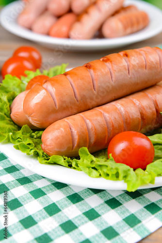 Grilled sausage on plate on table close-up
