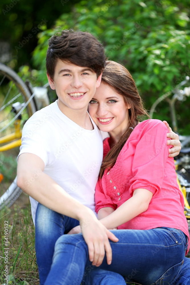 Young couple sitting in park Young couple sitting in park
