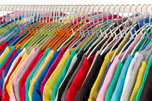 Colored shirts on hangers steel closeup.