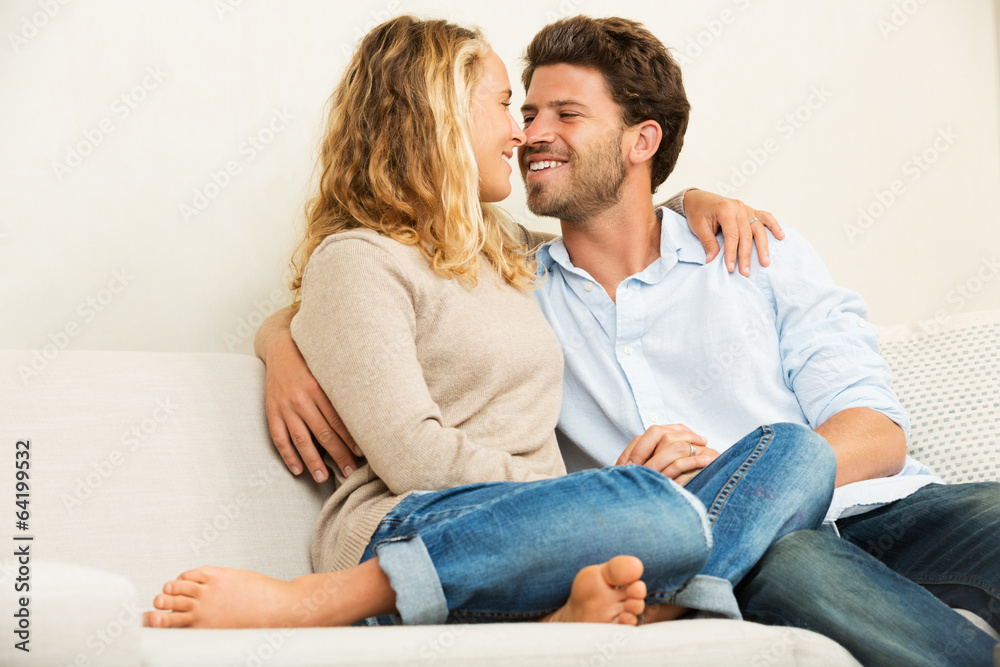 Happy young couple at home on sofa Happy young couple at home on sofa