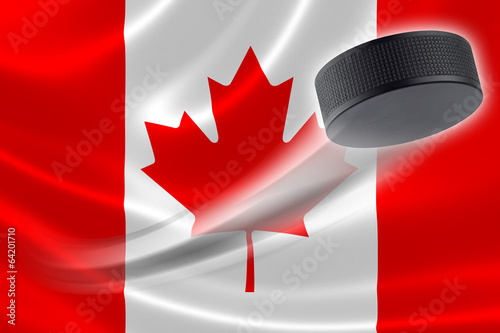 Hockey Puck Streaks Across Canadian Flag photo