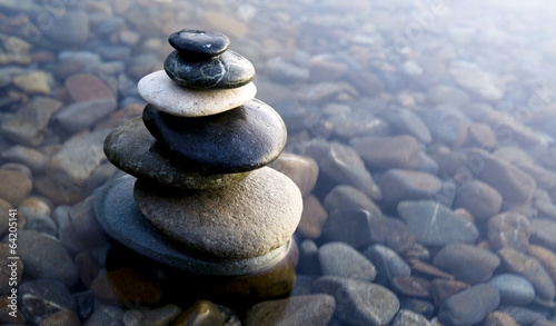 Zen Balancing Rocks on Pebbles Covered with Water photo