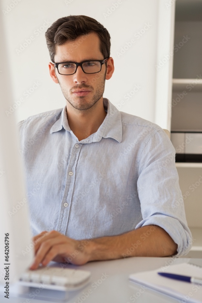 Fototapeta premium Casual businessman working at his desk