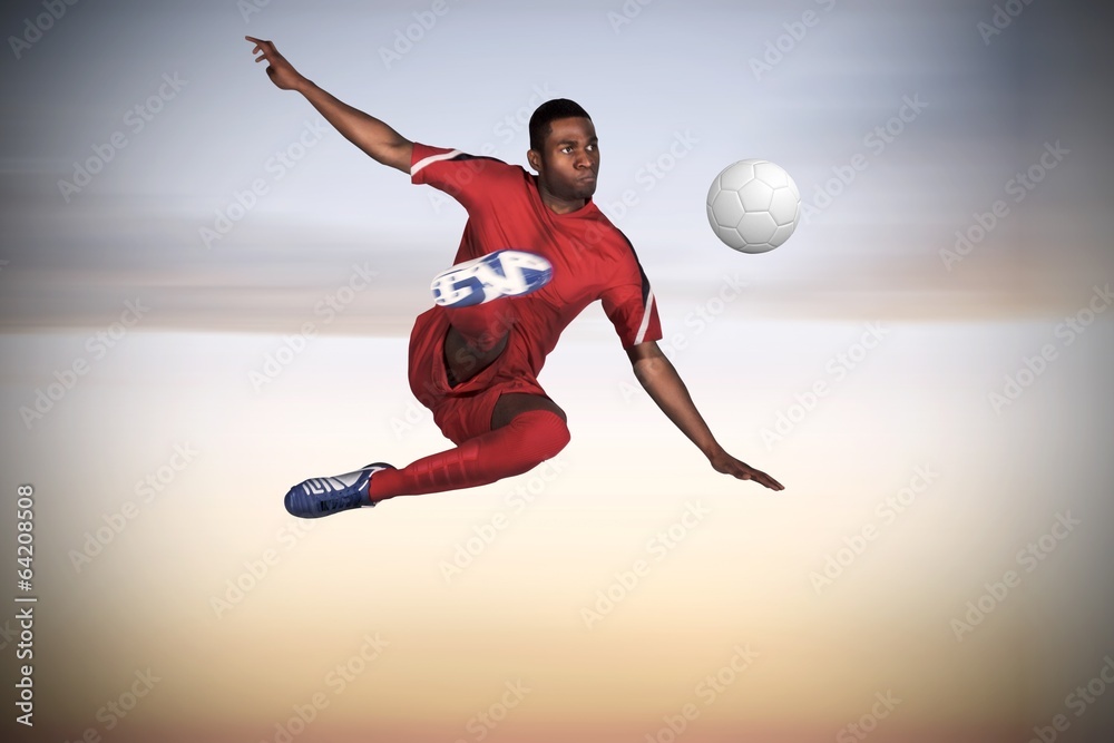 Composite image of football player in red kicking Composite image of football player in red kicking