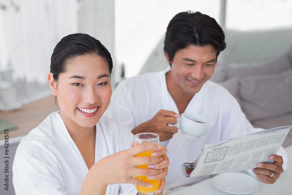 Couple in bathrobes spending the morning together Couple in bathrobes spending the morning together