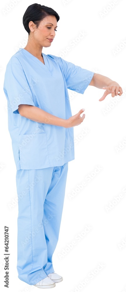 Pretty dark haired surgeon gesturing Pretty dark haired surgeon gesturing