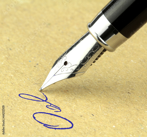Fountain pen writing on the paper, macro shot. photo