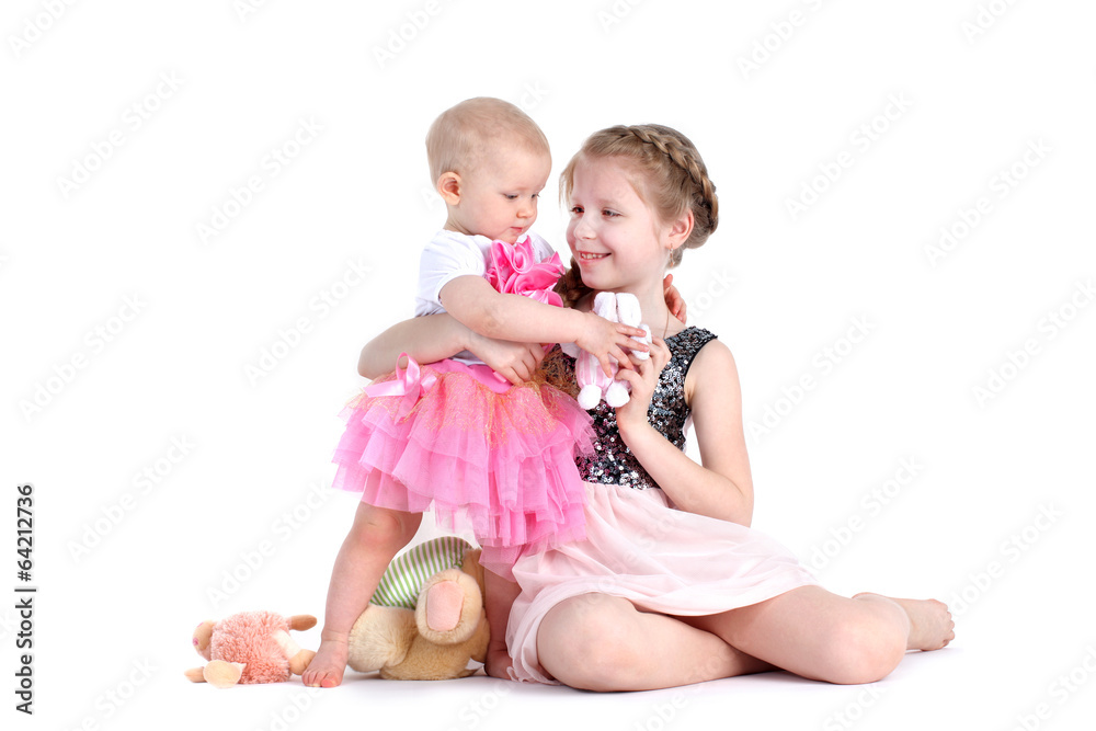 adorable little two sisters 8 year and 11 month old on white ba adorable little two sisters 8 year and 11 month old on white ba