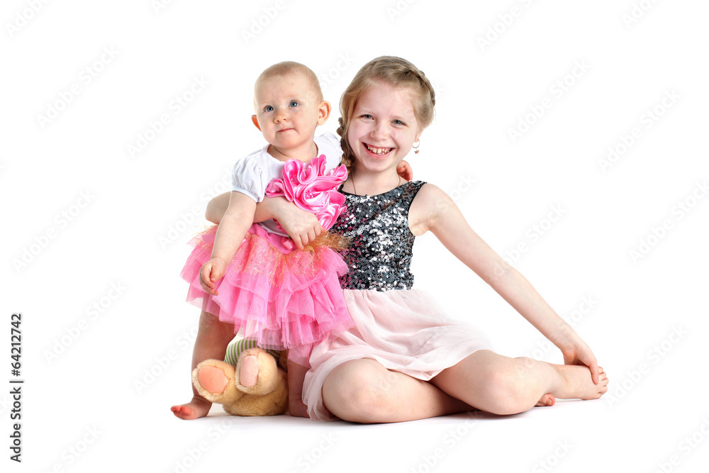 adorable little two sisters 8 year and 11 month old on white ba adorable little two sisters 8 year and 11 month old on white ba