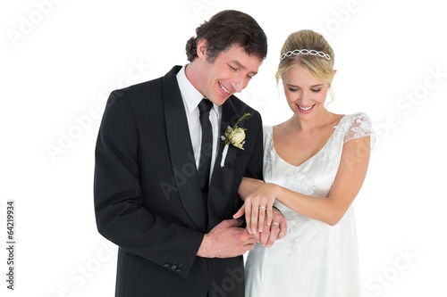 Newlywed couple looking at wedding rings