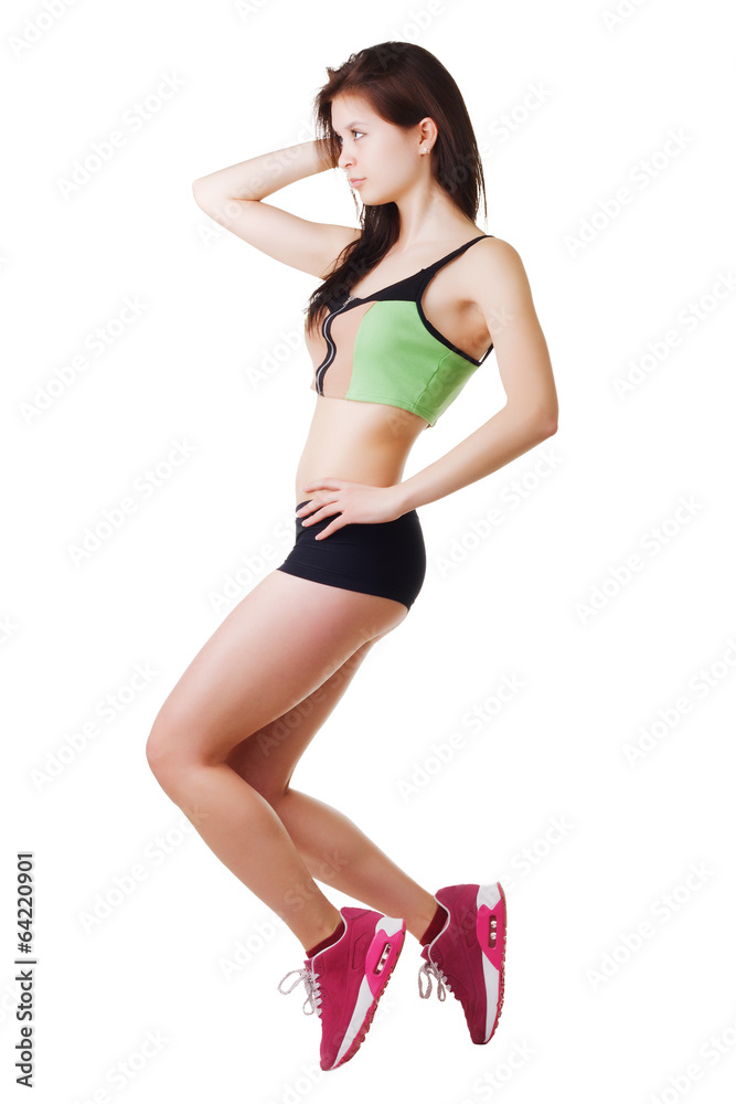 Athletic girl in T-shirt and short shorts performs an exercise. Athletic girl in T-shirt and short shorts performs an exercise.