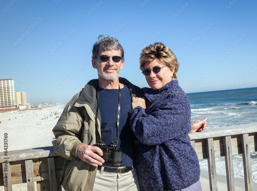 Happy Retired Couple on Fishing Pier at Sunny Beach