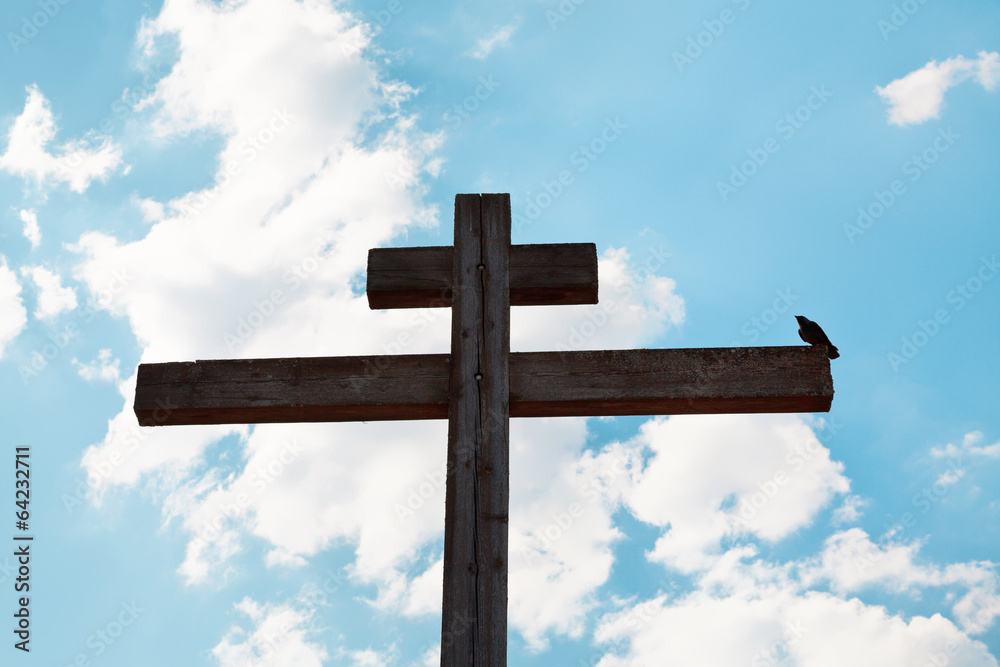 wooden orthodox cross, crow and blue sky