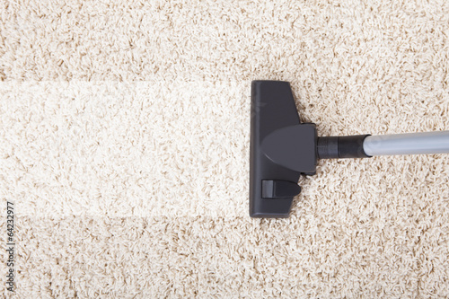 Vacuum Cleaner On Rug At Home photo