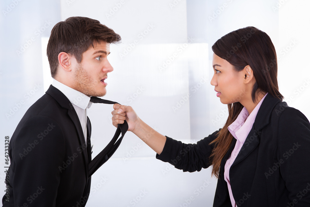 Angry Businesswoman Holding Businessman's Tie Angry Businesswoman Holding Businessman's Tie
