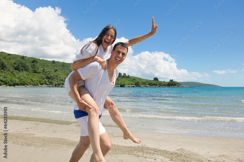 happy couple have fun on the beach