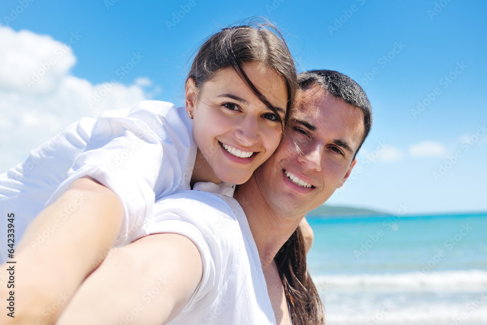 happy couple have fun on the beach happy couple have fun on the beach