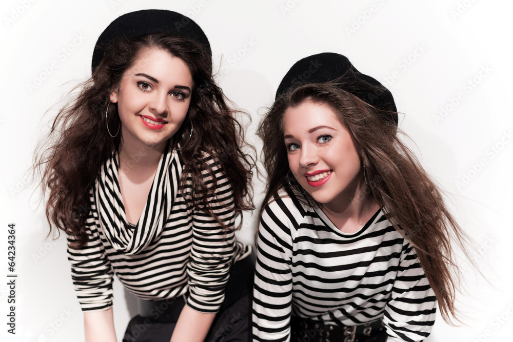 Two bold eighties fashion girls in black and white. Studio shot Two bold eighties fashion girls in black and white. Studio shot