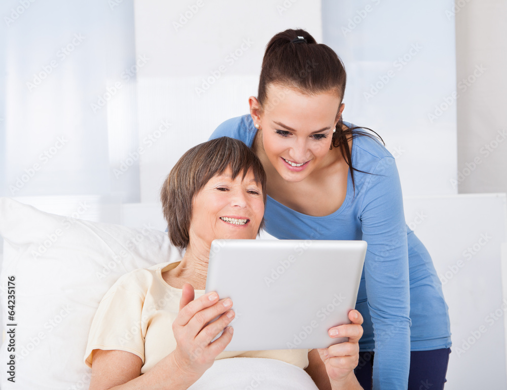Caregiver And Senior Woman Using Digital Tablet Caregiver And Senior Woman Using Digital Tablet