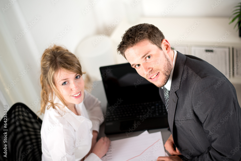 portrait of two business people working together in office portrait of two business people working together in office