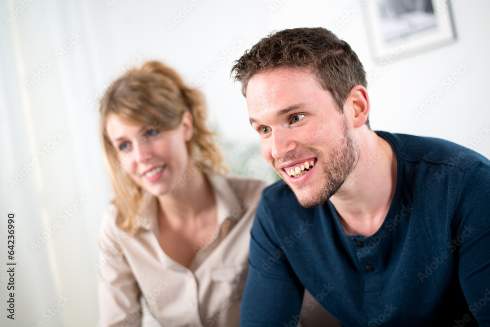 cheerful young couple with salesman at home cheerful young couple with salesman at home