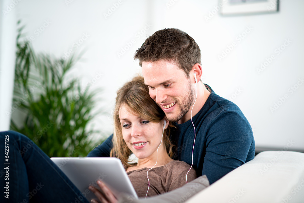 portrait of a cheerful young couple relaxed at home portrait of a cheerful young couple relaxed at home