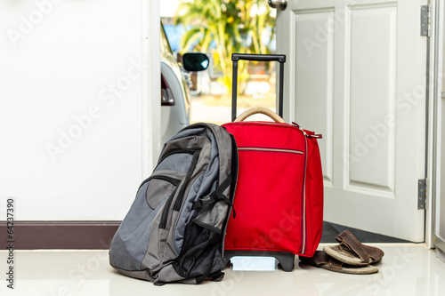 red travel bag , backpack and shoes
