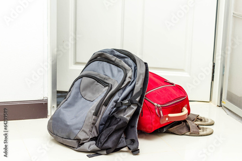 red travel bag , backpack and shoes