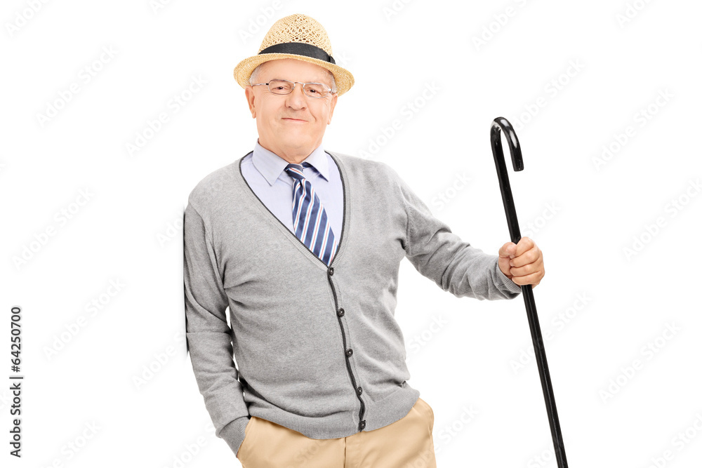 Senior gentleman with cane, leaning against a wall Senior gentleman with cane, leaning against a wall