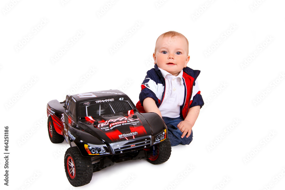 Fototapeta premium little boy plays with toy car
