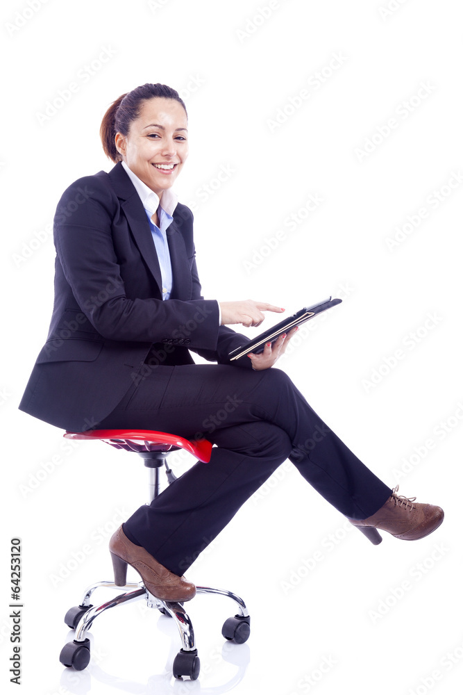 Businesswoman sitting on chair working with a tablet computer, i Businesswoman sitting on chair working with a tablet computer, i