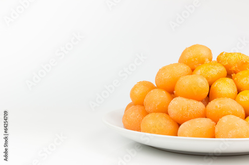 Gold egg yolks drops isolated on white background.
