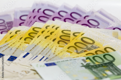 Isolated stack of money with 100 200 and 500 euro banknotes.