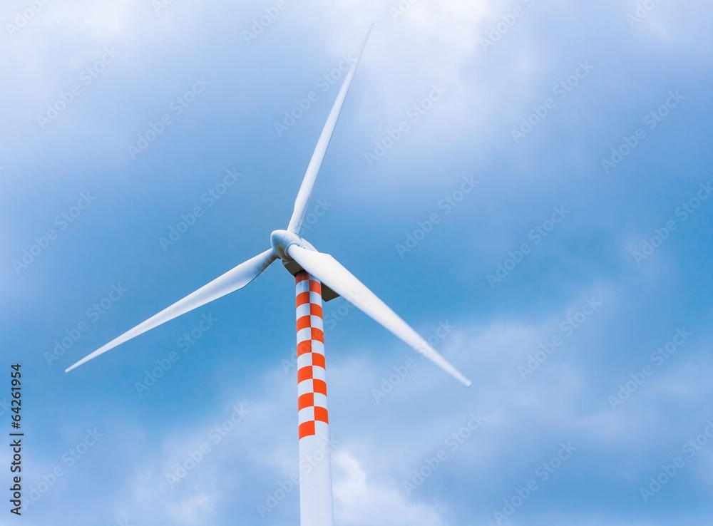 wind turbine in movement under blue sky and clouds wind turbine in movement under blue sky and clouds